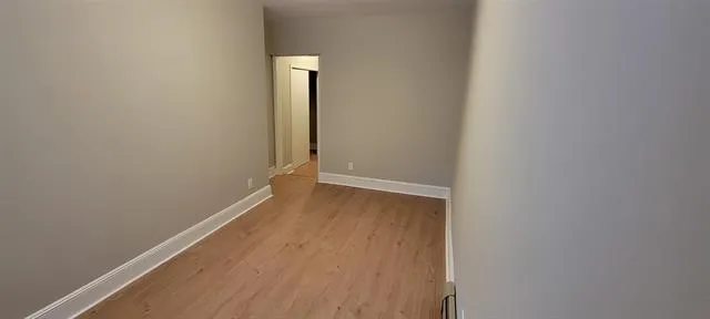 a view of a room with wooden floor