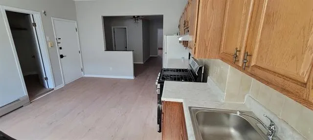a view of a kitchen from a hallway