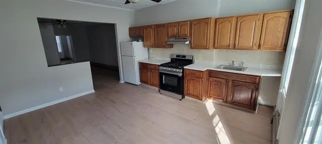 a kitchen with a sink cabinets and stainless steel appliances