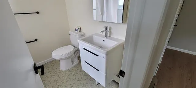 a bathroom with a sink toilet and mirror