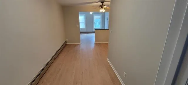 a view of a hallway with wooden floor