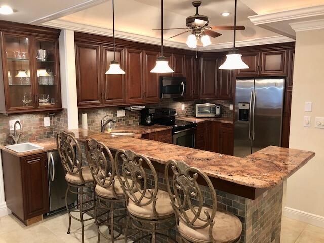197 Durango Road, Unit 6C Destin, FL 32541 - Photo 14 of 62 a kitchen with stainless steel appliances granite countertop a sink a stove and refrigerator