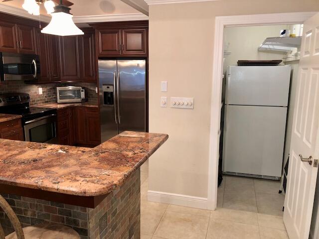 197 Durango Road, Unit 6C Destin, FL 32541 - Photo 15 of 62 a kitchen with stainless steel appliances granite countertop a refrigerator a stove and a sink