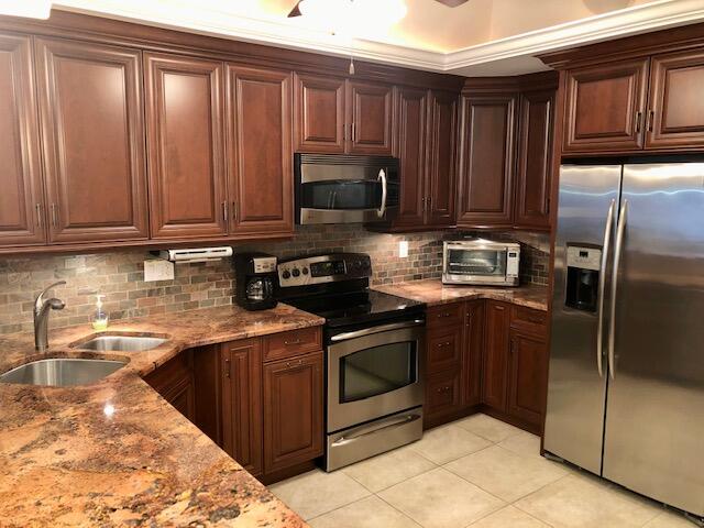 197 Durango Road, Unit 6C Destin, FL 32541 - Photo 16 of 62 a kitchen with a sink stove and refrigerator