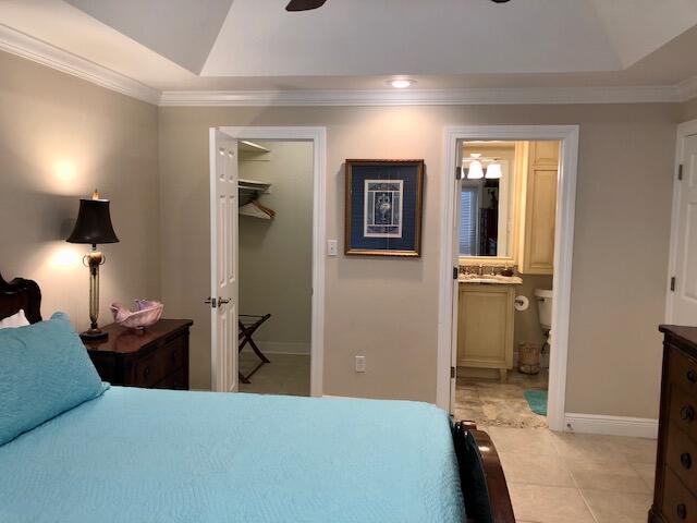 197 Durango Road, Unit 6C Destin, FL 32541 - Photo 29 of 62 a bedroom with a bed and a lamp