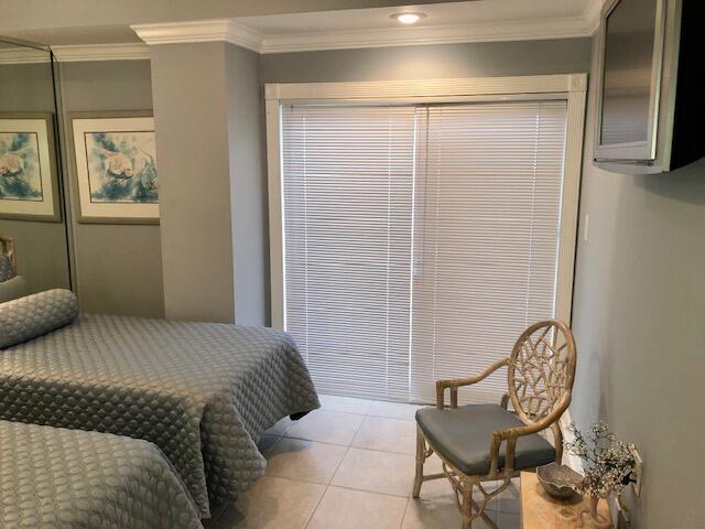 197 Durango Road, Unit 6C Destin, FL 32541 - Photo 33 of 62 a bedroom with a bed and a chair