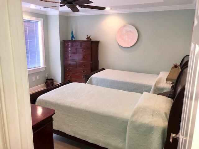 197 Durango Road, Unit 6C Destin, FL 32541 - Photo 35 of 62 a bedroom with a bed and a mirror