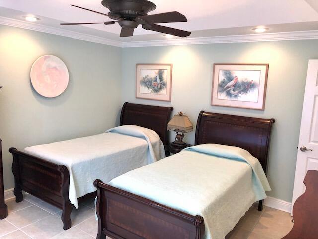 197 Durango Road, Unit 6C Destin, FL 32541 - Photo 37 of 62 a bedroom with bed and a chandelier