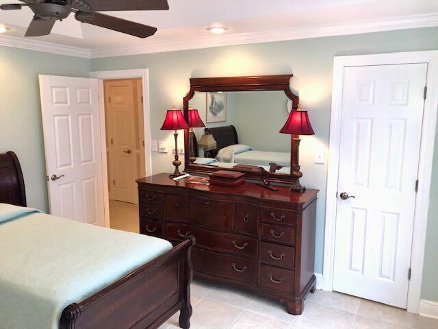 197 Durango Road, Unit 6C Destin, FL 32541 - Photo 39 of 62 a bed room with a bed and a dresser