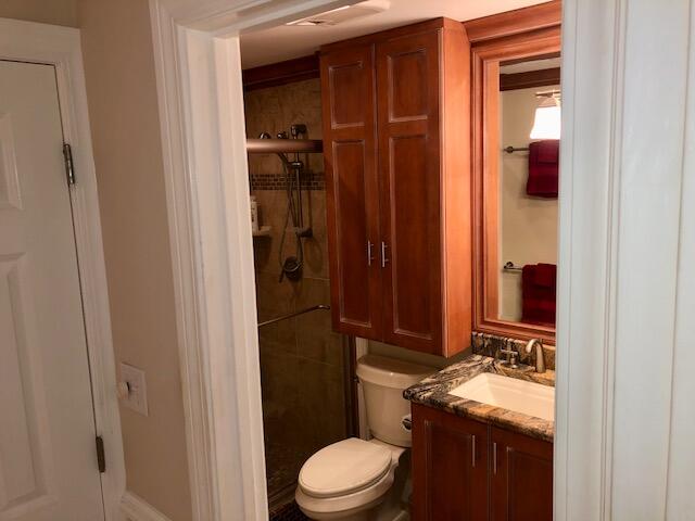 197 Durango Road, Unit 6C Destin, FL 32541 - Photo 42 of 62 a bathroom with a granite countertop sink toilet and shower