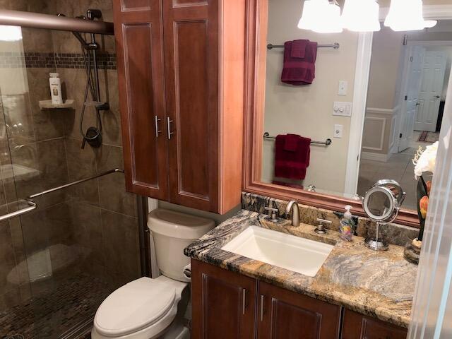 197 Durango Road, Unit 6C Destin, FL 32541 - Photo 43 of 62 a bathroom with a granite countertop sink toilet and shower