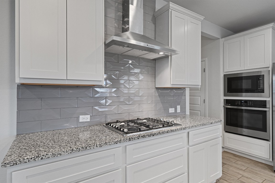 300 Delta Crest Maxwell, TX 78656 - Photo 9 of 36 a kitchen with granite countertop stainless steel appliances and cabinets