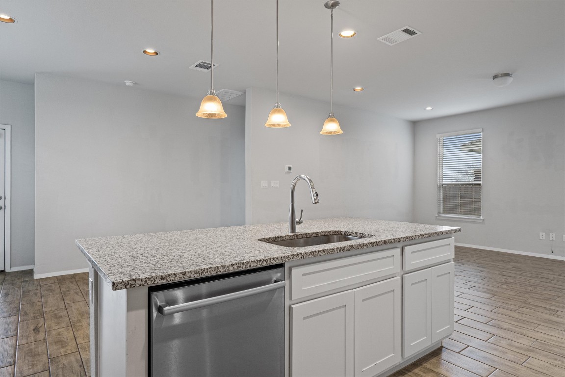 300 Delta Crest Maxwell, TX 78656 - Photo 10 of 36 a kitchen that has a sink a stove and a wooden floors
