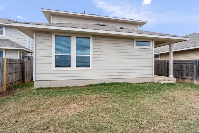 a view of a house with backyard and porch