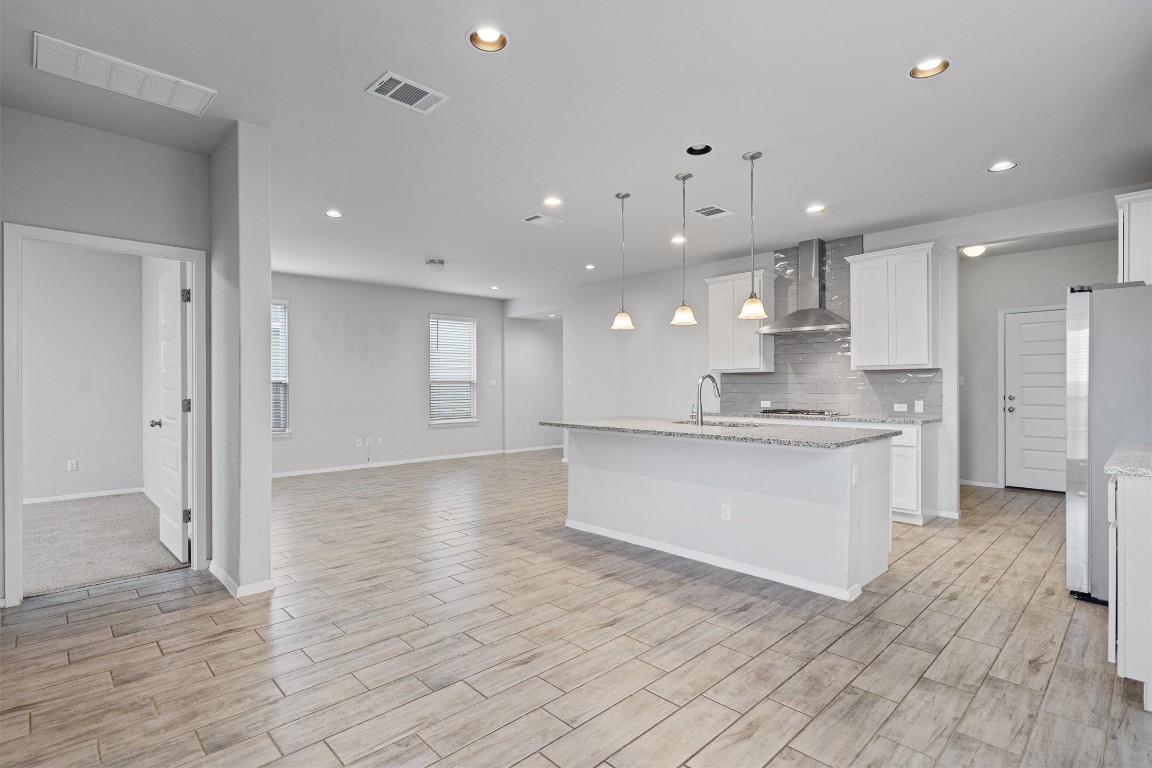 300 Delta Crest Maxwell, TX 78656 - Photo 36 of 36 a large white kitchen with kitchen island a sink stainless steel appliances and cabinets