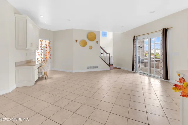 a living room with furniture a chandelier and a large window