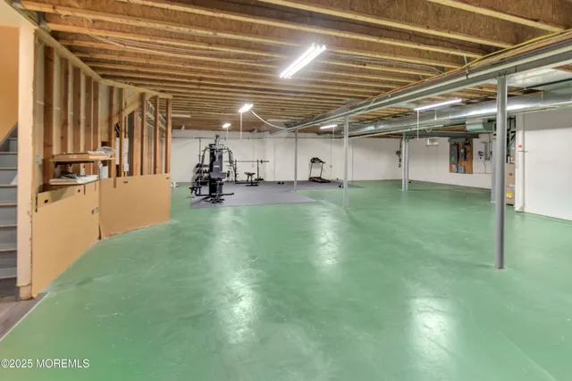 a bedroom with a bed and a dresser next to a window