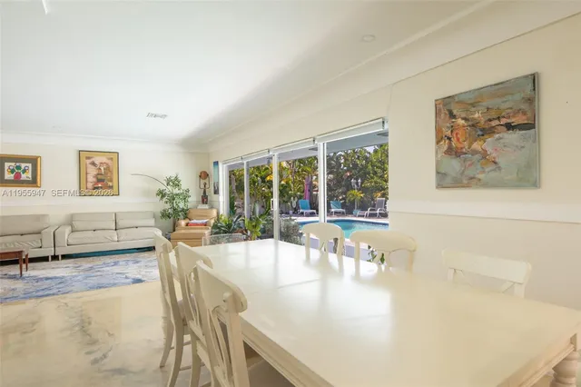 a living room with fireplace furniture and a large window