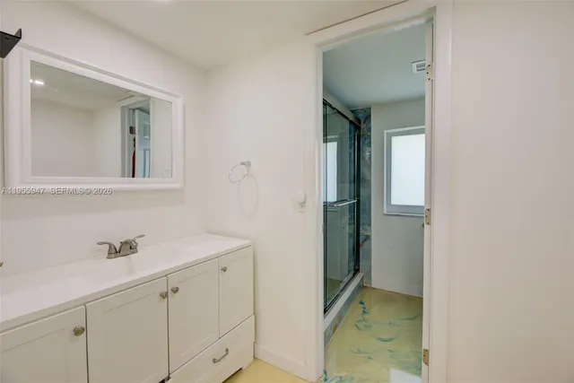 a bathroom with a sink and mirror