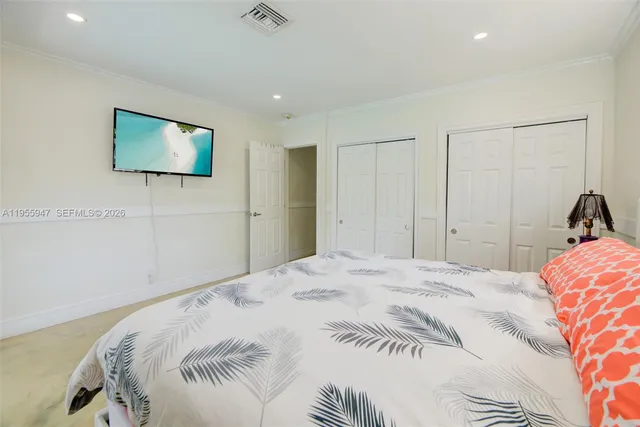 a bedroom with a bed and a lamp