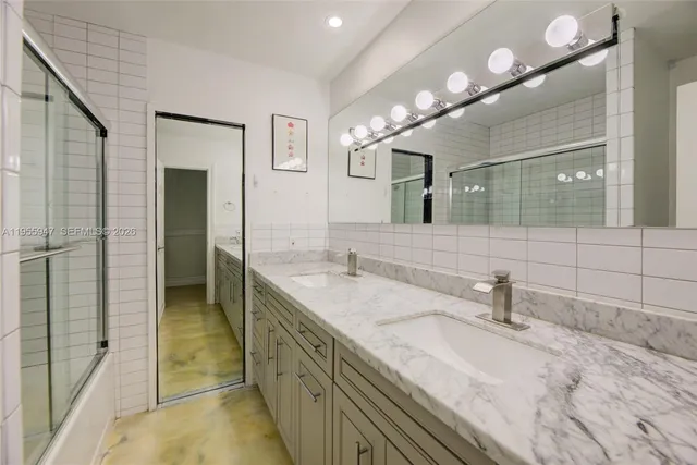 a bathroom with a double vanity sink and a mirror