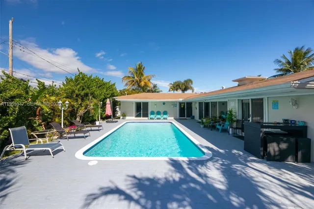 a view of a house with a yard porch and furniture