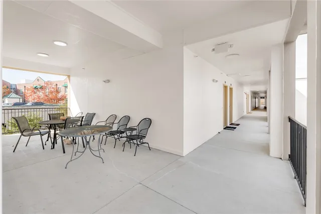 a view of a dining room with furniture and a floor to ceiling window