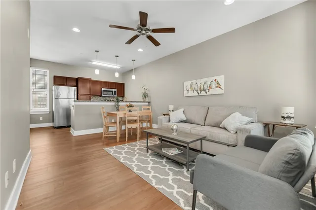 a living room with furniture and kitchen view