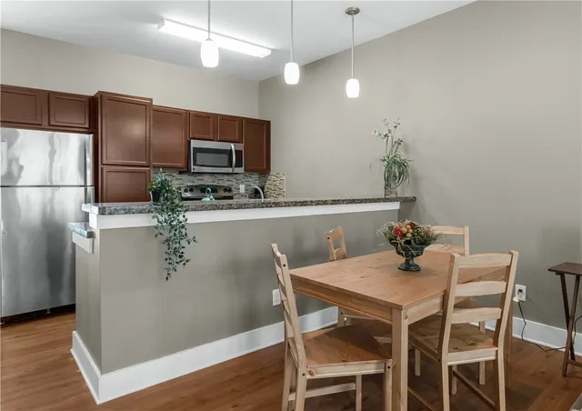 a view of a dining room with furniture and wooden floor