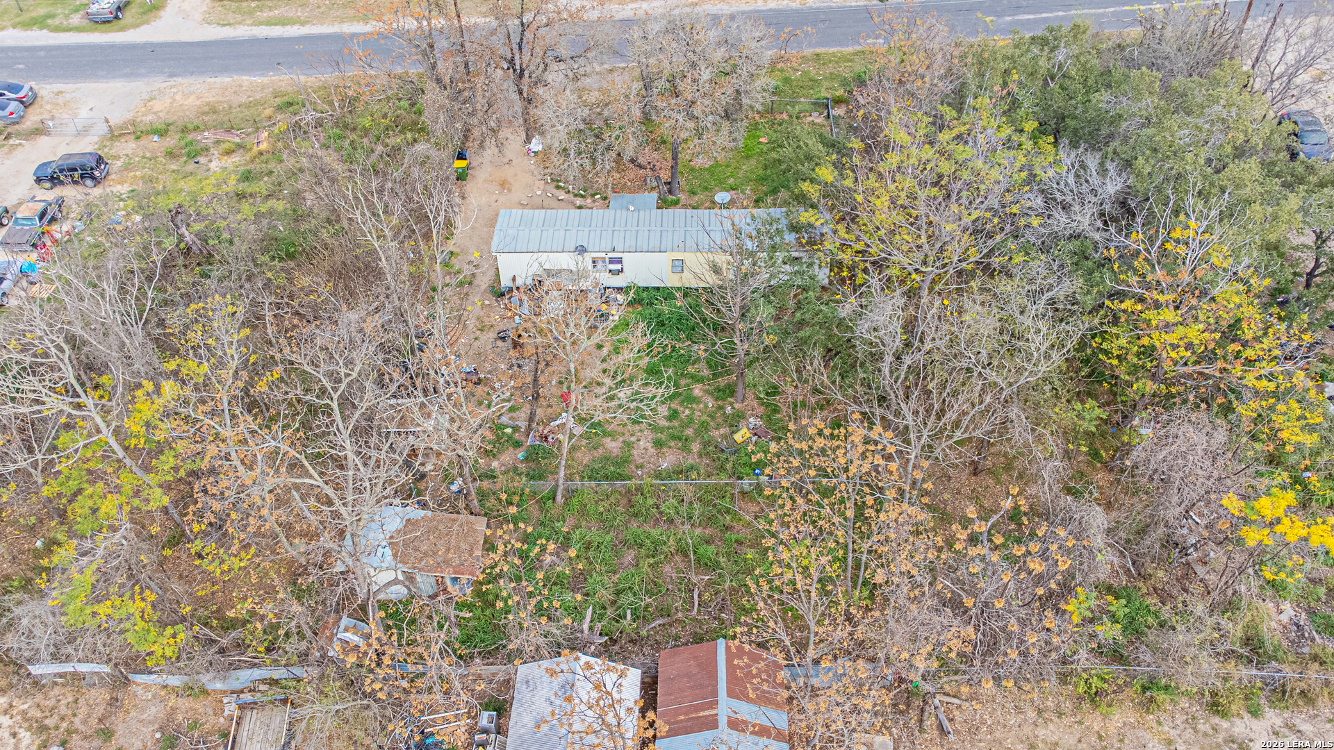 369 Gateway Drive Poteet, TX 78065 - Photo 14 of 45 a picture of a building with a yard and large trees