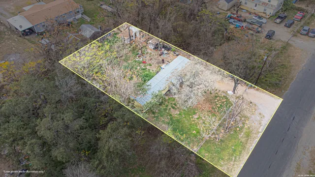 a view of a house with backyard and a tree