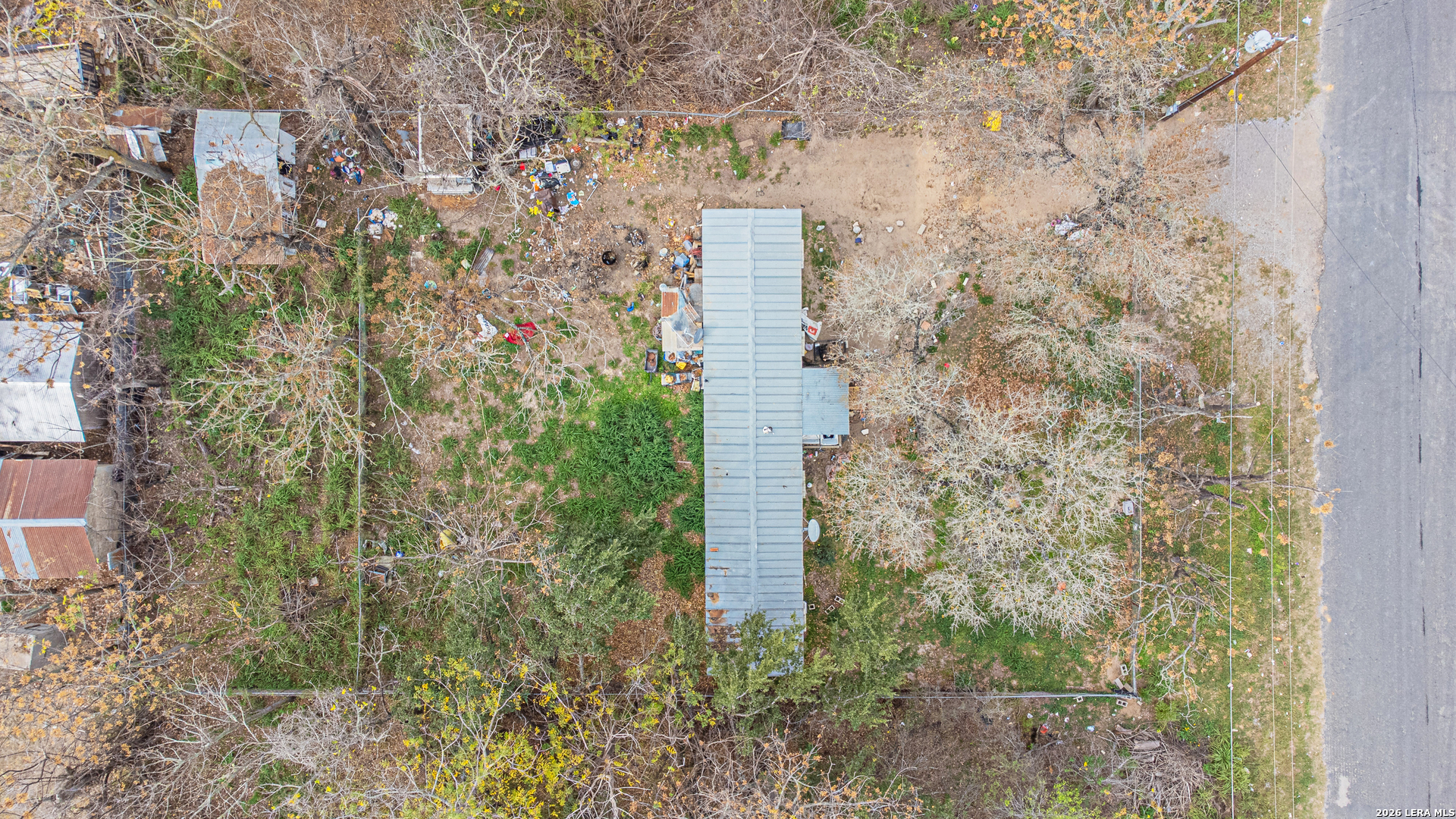 369 Gateway Drive Poteet, TX 78065 - Photo 22 of 45 a aerial view of a house with a yard and large trees