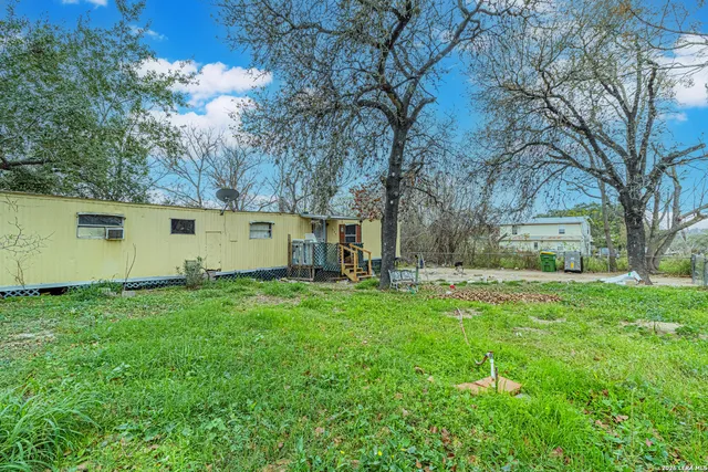 a backyard of a house with table and chairs
