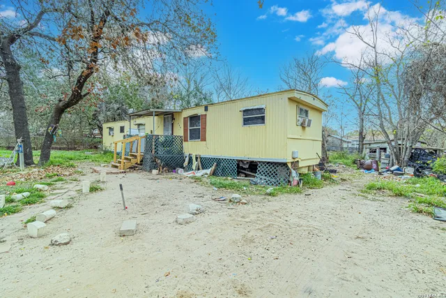 a view of a yard with a house and a trees