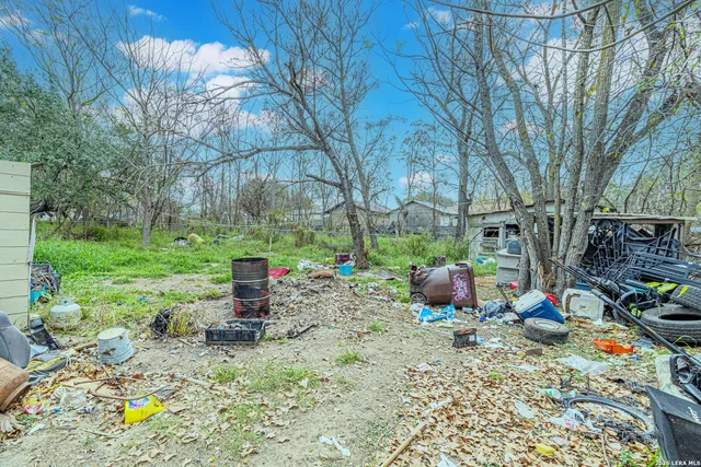 a view of a yard with a house and a tree