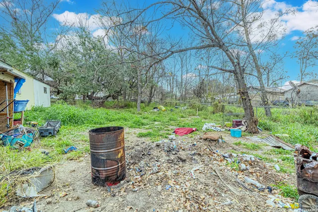 a view of a yard with a house and a tree