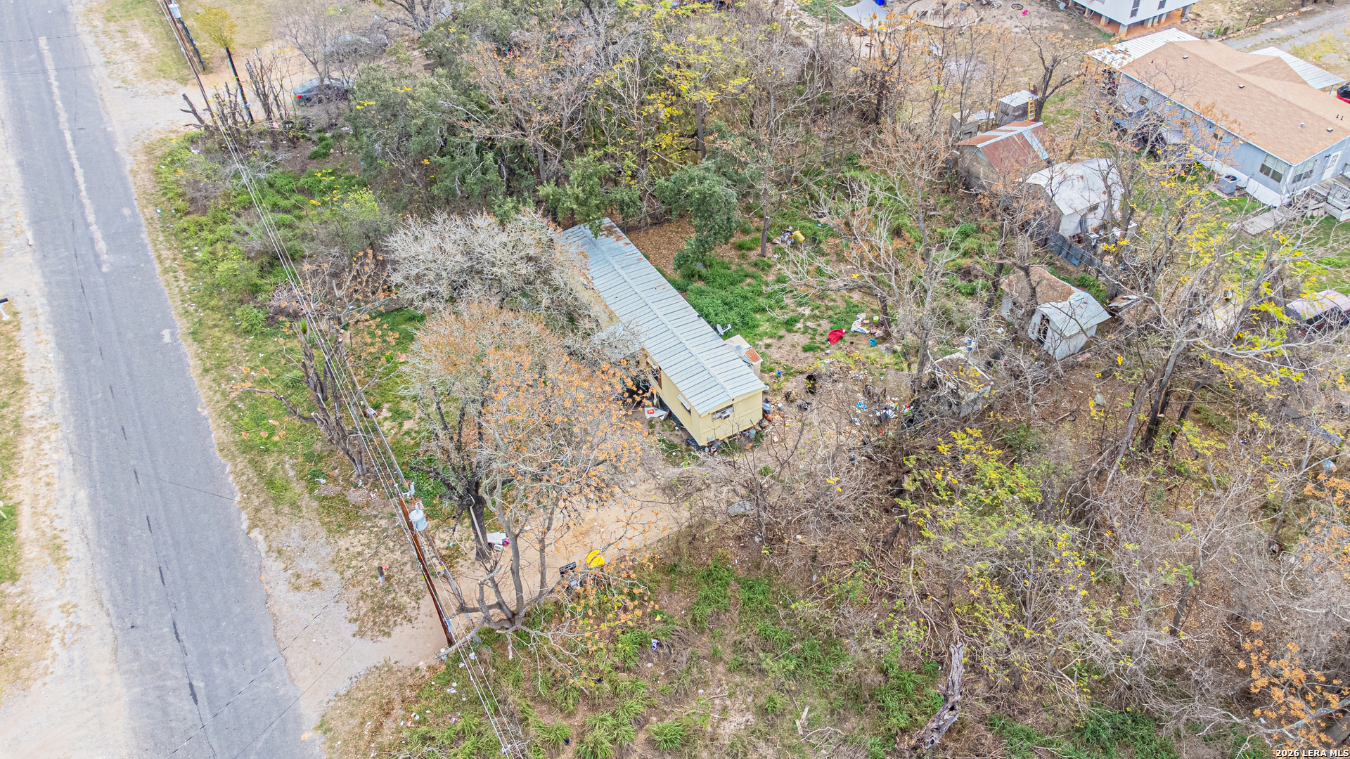 369 Gateway Drive Poteet, TX 78065 - Photo 7 of 45 a view of a yard with plants and large trees