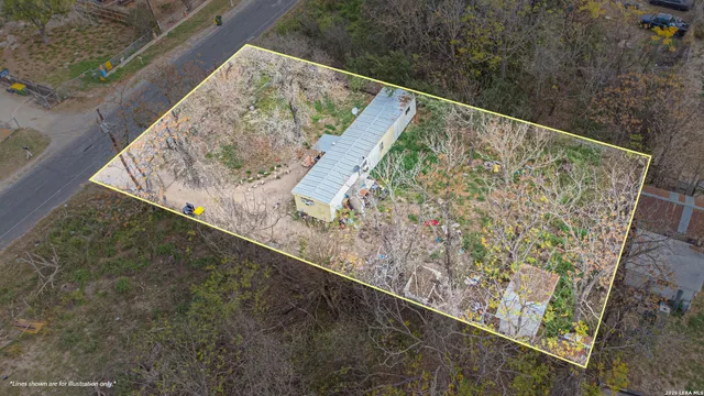 a aerial view of a house with a yard and garden