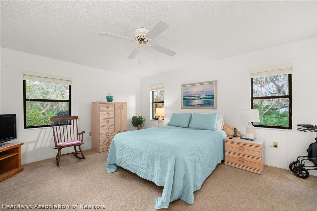 5802 Golden Road Sebring, FL 33875 - Photo 15 of 37 a bedroom with a bed and a couch