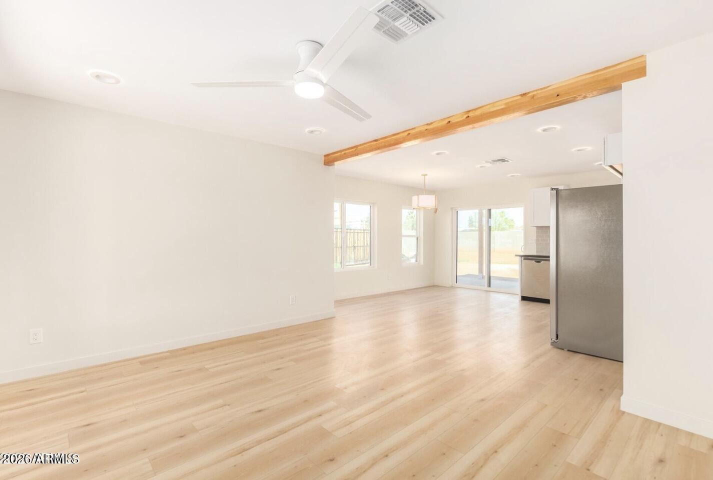 902 East Fairmount Avenue Phoenix, AZ 85014 - Photo 12 of 28 a view of an empty room with wooden floor and a window