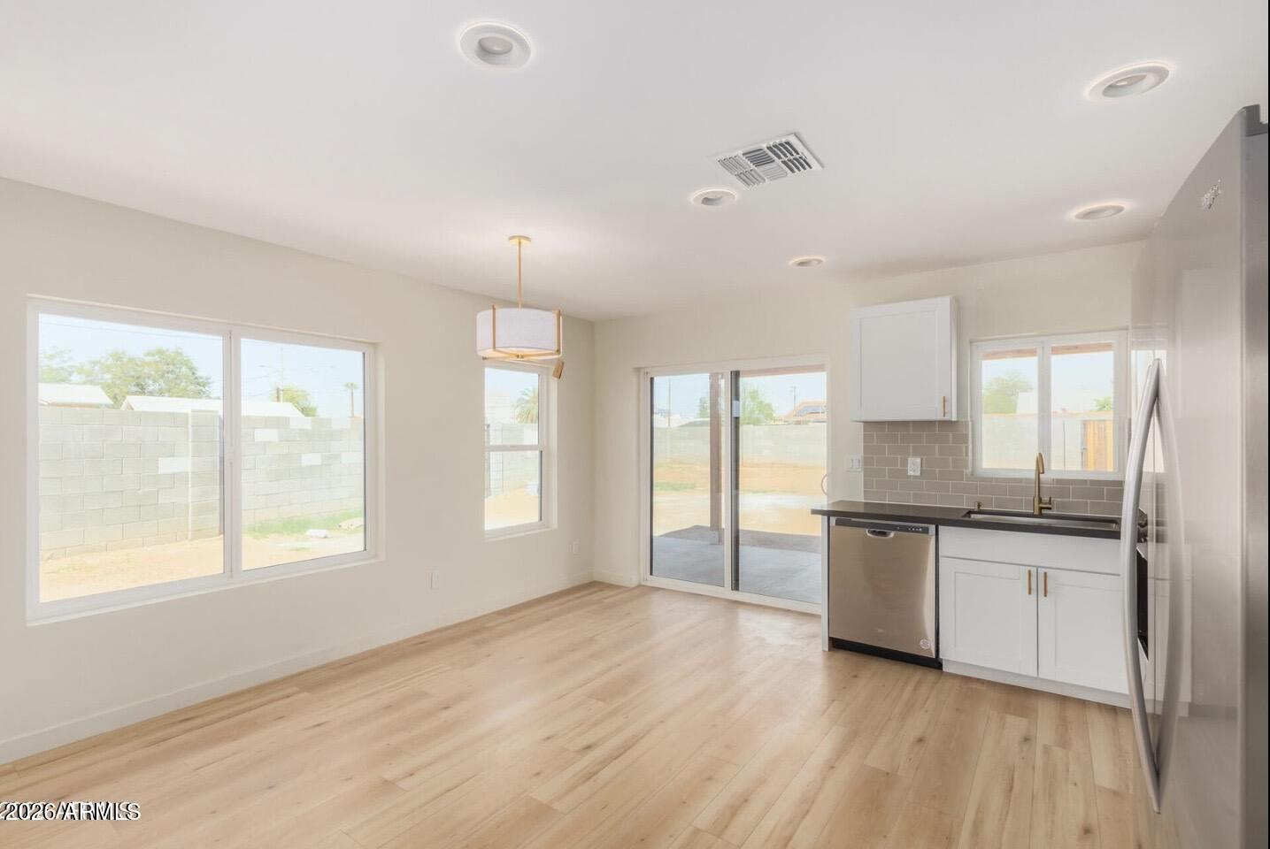 902 East Fairmount Avenue Phoenix, AZ 85014 - Photo 13 of 28 a large kitchen with granite countertop a stove top oven sink and cabinets