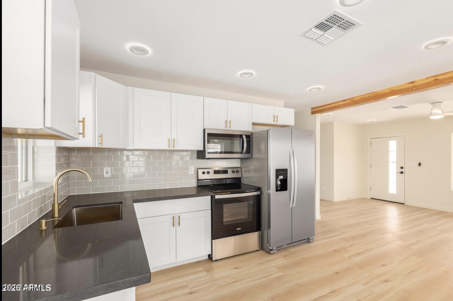 902 East Fairmount Avenue Phoenix, AZ 85014 - Photo 14 of 28 a kitchen with granite countertop a refrigerator and a sink