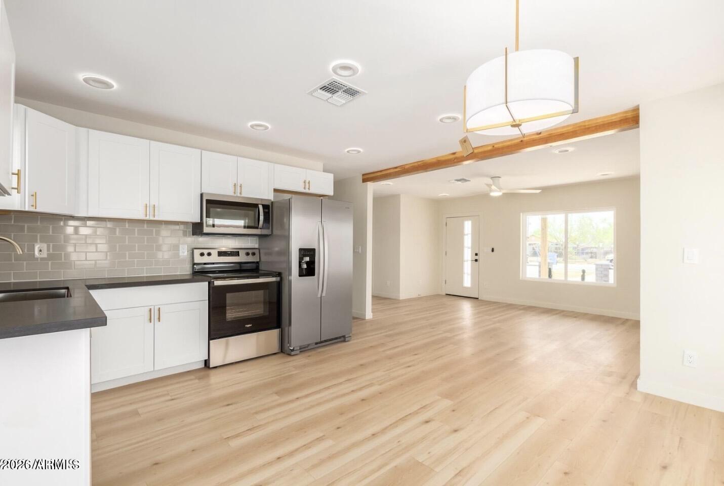 902 East Fairmount Avenue Phoenix, AZ 85014 - Photo 15 of 28 a kitchen with stainless steel appliances a refrigerator sink and microwave