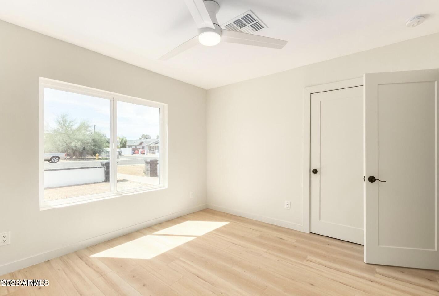 902 East Fairmount Avenue Phoenix, AZ 85014 - Photo 24 of 28 a view of an empty room with wooden floor and a window
