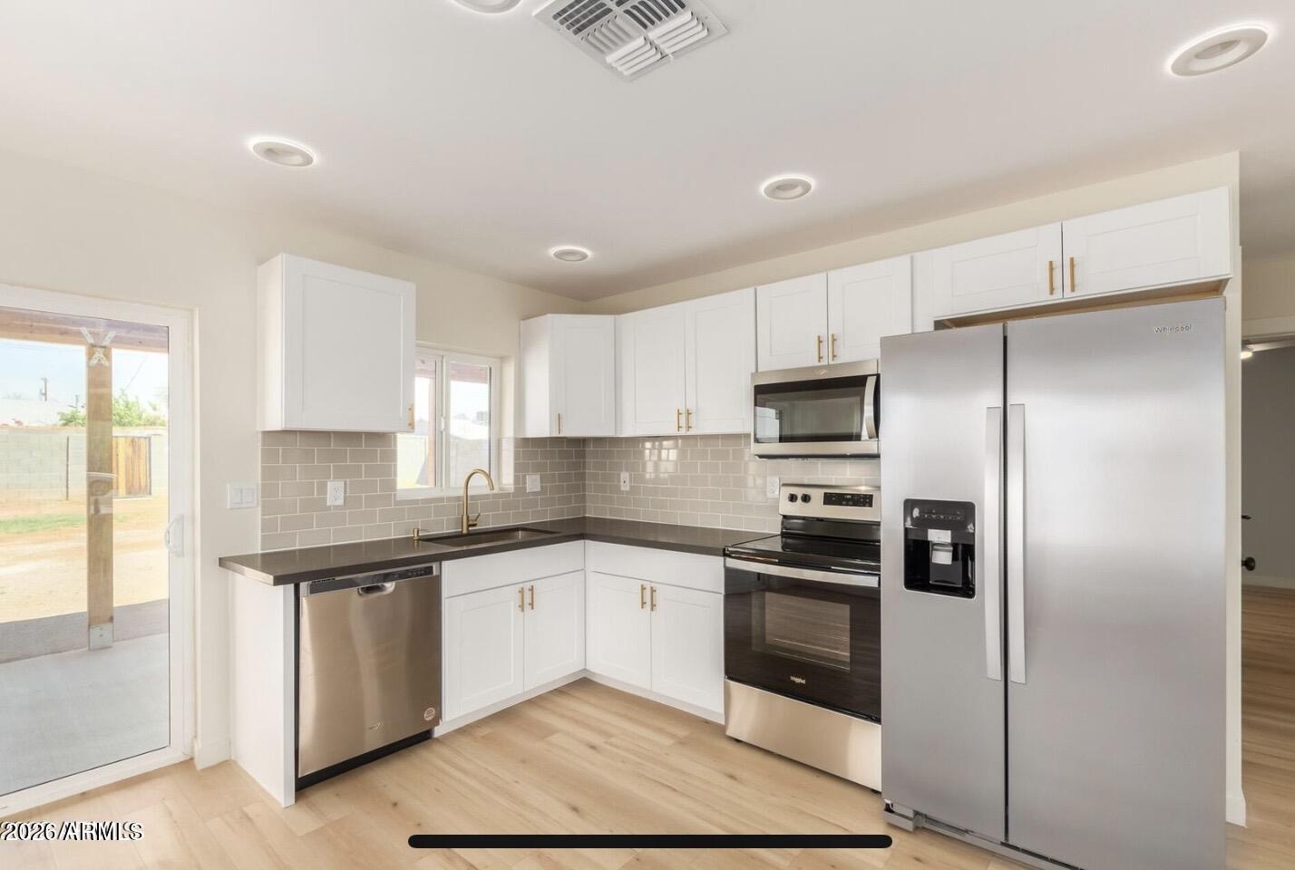 902 East Fairmount Avenue Phoenix, AZ 85014 - Photo 3 of 28 a kitchen with stainless steel appliances granite countertop a stove and a refrigerator