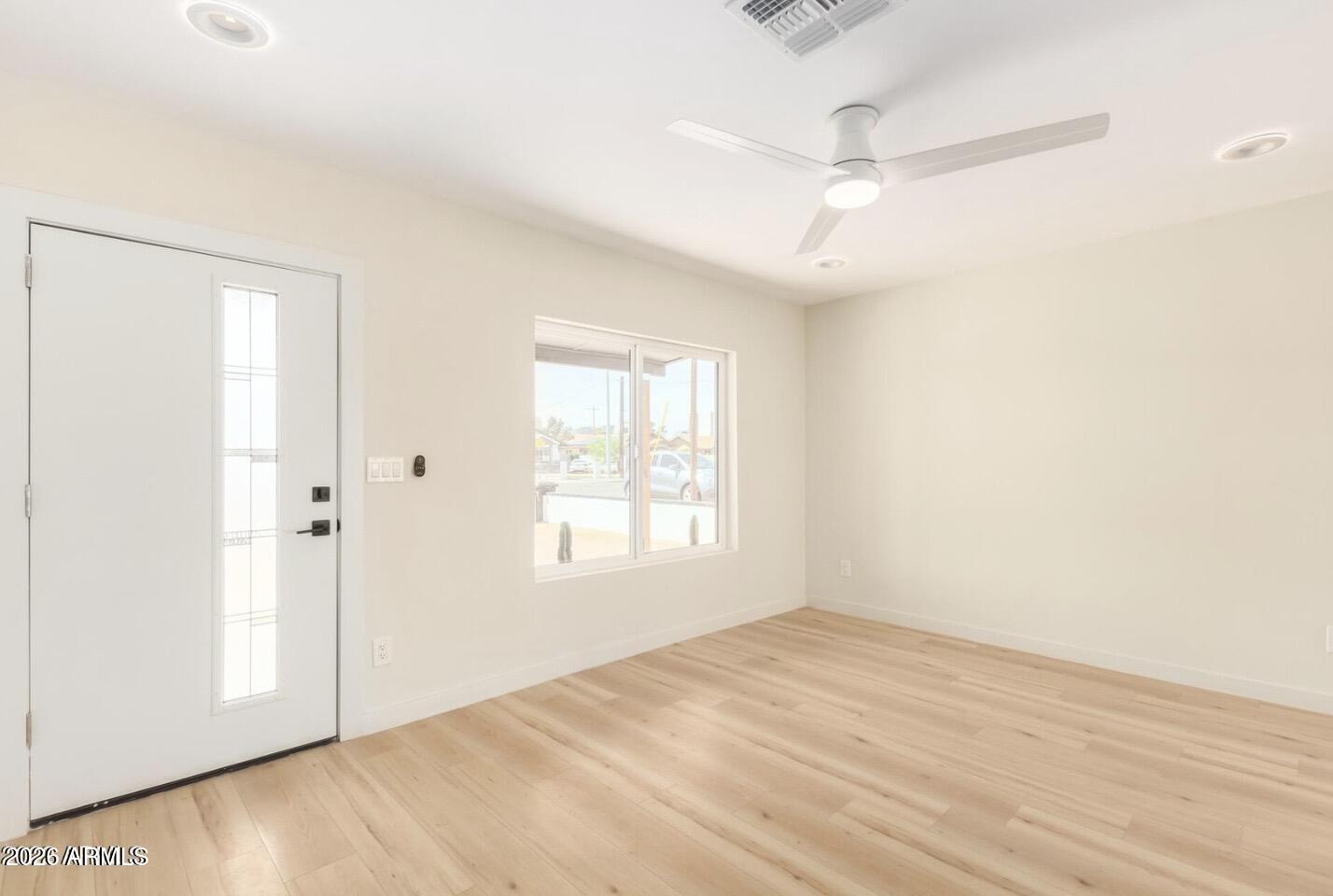 902 East Fairmount Avenue Phoenix, AZ 85014 - Photo 10 of 28 an empty room with windows and fan