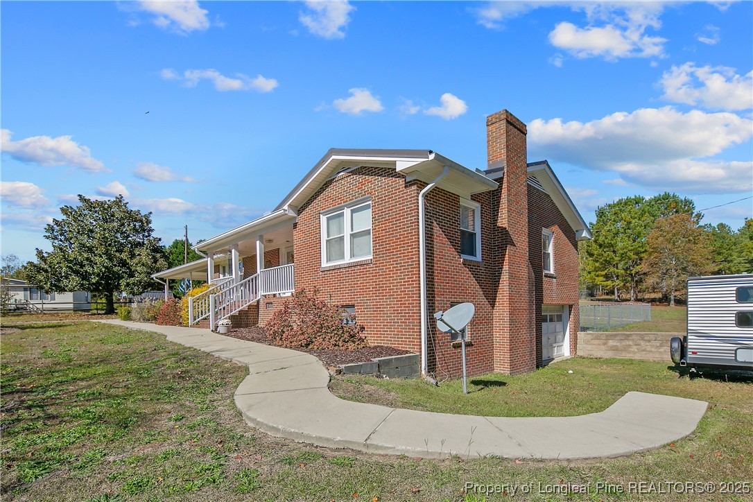 7666 Overhills Road Spring Lake, NC 28390 - Photo 2 of 50 a front view of a house with a yard