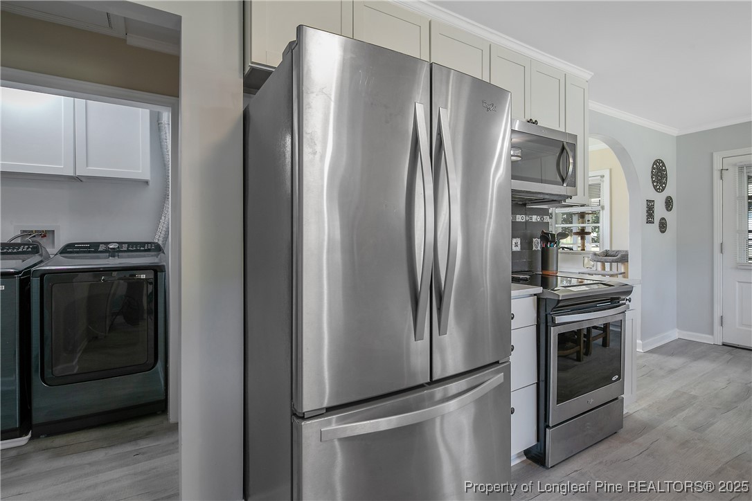 7666 Overhills Road Spring Lake, NC 28390 - Photo 21 of 50 a metallic refrigerator freezer sitting in a kitchen