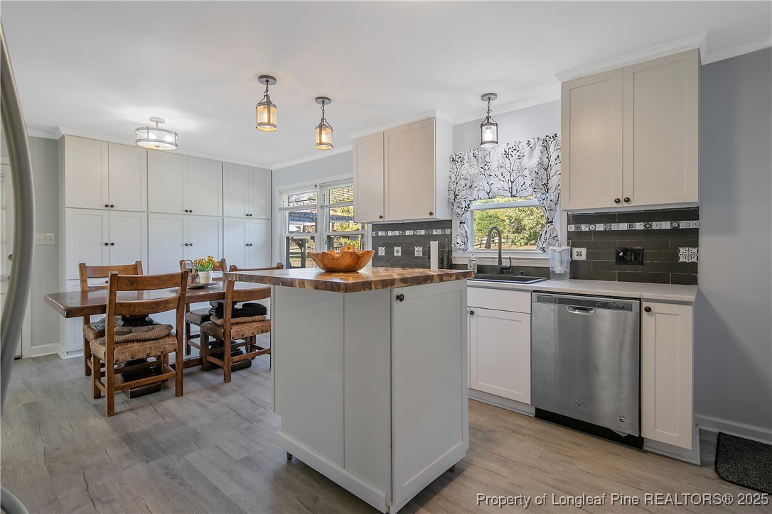 7666 Overhills Road Spring Lake, NC 28390 - Photo 22 of 50 a kitchen with sink cabinets and window
