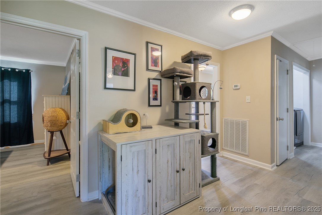 7666 Overhills Road Spring Lake, NC 28390 - Photo 25 of 50 double view of a livingroom with furniture and wooden floor